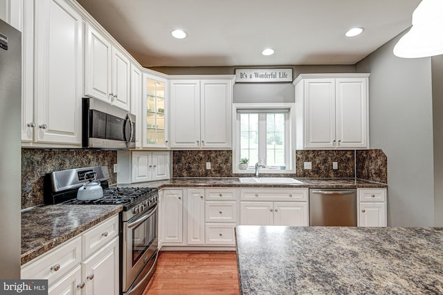 66 Light Farm Dr, Cochranville, PA 19330 - kitchen with appliances with stainless steel finishes, white cabinets, light wood finished floors, dark stone countertops, and recessed lighting