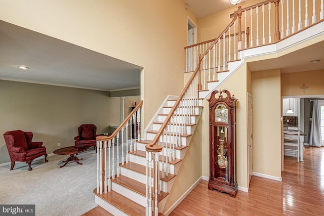 66 Light Farm Dr, Cochranville, PA 19330 - staircase featuring wood finished floors, crown molding, and a high ceiling
