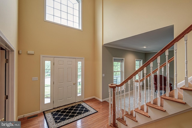 66 Light Farm Dr, Cochranville, PA 19330 - entryway featuring wood-type flooring, stairs, crown molding, and a high ceiling