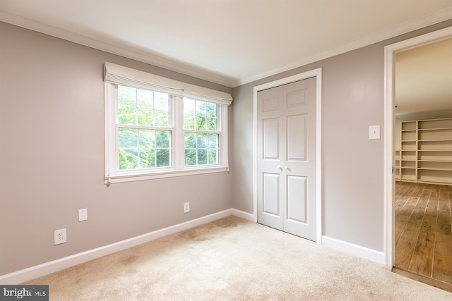 27 Cascade Rd, Arnold, MD 21012 - unfurnished bedroom with crown molding, a closet, and light colored carpet