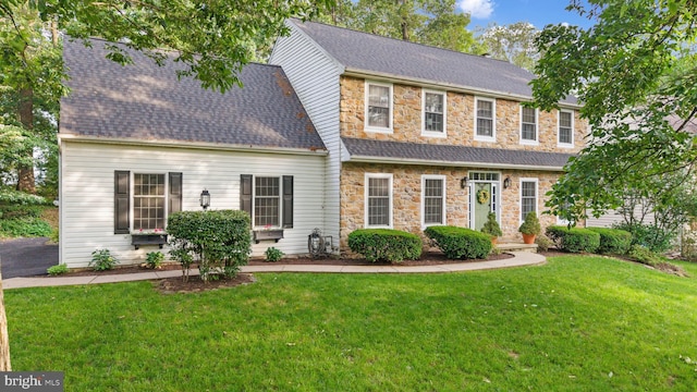 130 W Crestlyn Dr, York, PA 17402 - view of front of property featuring stone siding, a front yard, and a shingled roof