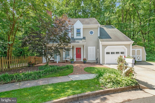 6943 Deer Run Dr, Alexandria, VA 22306 - view of front of house featuring covered porch, concrete driveway, an attached garage, a storage shed, and roof with shingles