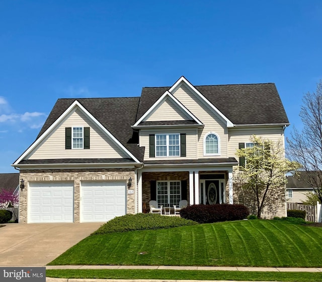 162 Darby Dr, Winchester, VA 22602 - traditional-style house featuring driveway, a porch, a front yard, an attached garage, and roof with shingles