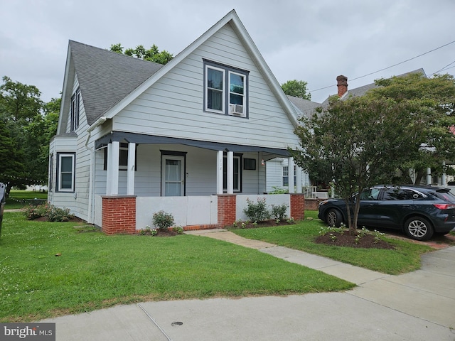116 Maple Ave, Preston, MD 21655 - bungalow featuring a porch, roof with shingles, and a front lawn