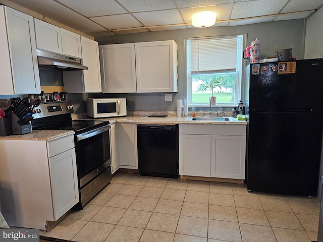 116 Maple Ave, Preston, MD 21655 - kitchen with black appliances, under cabinet range hood, a sink, a drop ceiling, and white cabinetry