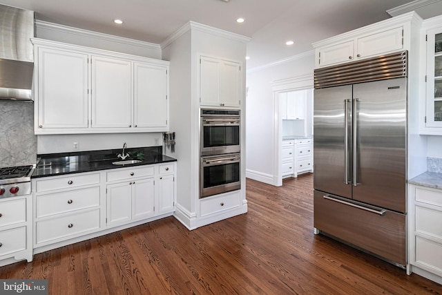 3 Evelyn Pl, Princeton, NJ 08540 - kitchen featuring appliances with stainless steel finishes, white cabinetry, dark wood-type flooring, ornamental molding, and recessed lighting