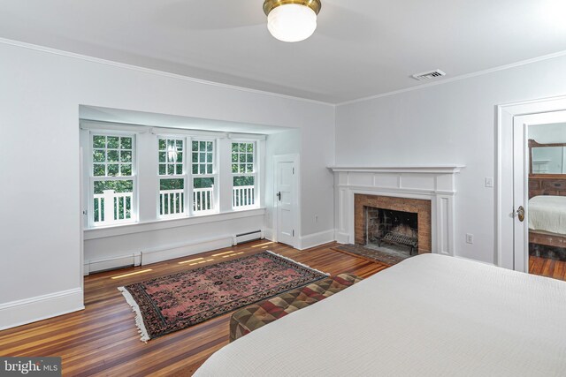 3 Evelyn Pl, Princeton, NJ 08540 - bedroom featuring ornamental molding, baseboard heating, wood finished floors, and a tiled fireplace