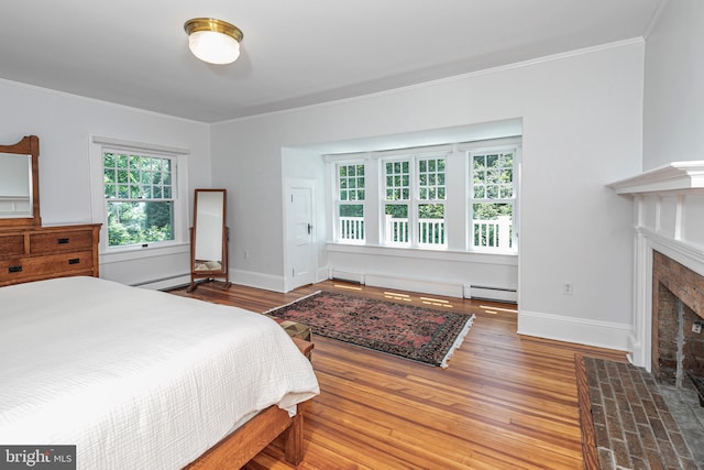 3 Evelyn Pl, Princeton, NJ 08540 - bedroom featuring a baseboard radiator, a fireplace with flush hearth, ornamental molding, wood finished floors, and a baseboard heating unit
