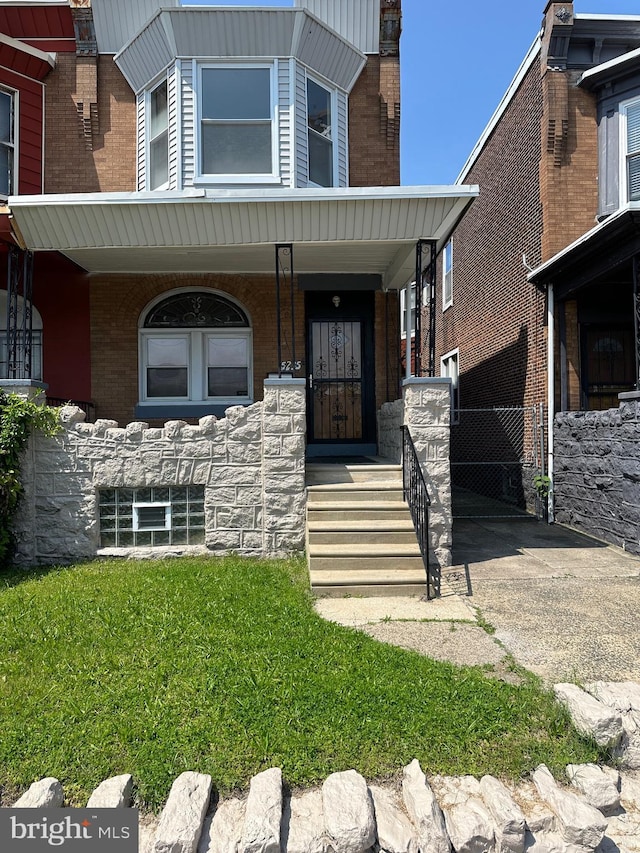 5235 Baltimore Ave, Philadelphia, PA 19143 - doorway to property featuring a porch and brick siding
