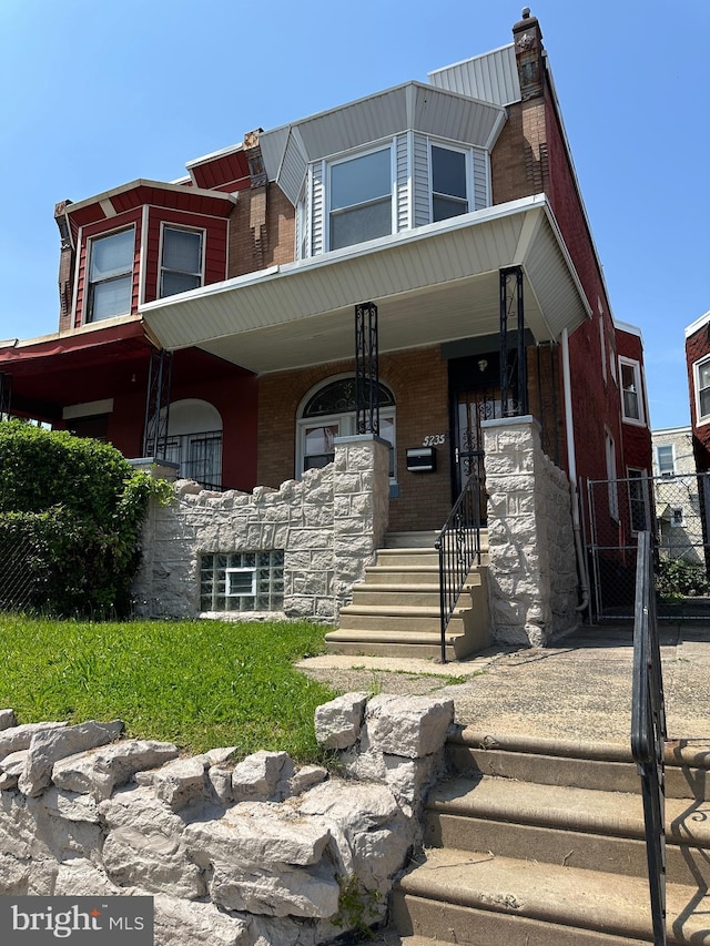 5235 Baltimore Ave, Philadelphia, PA 19143 - view of front facade with covered porch and brick siding