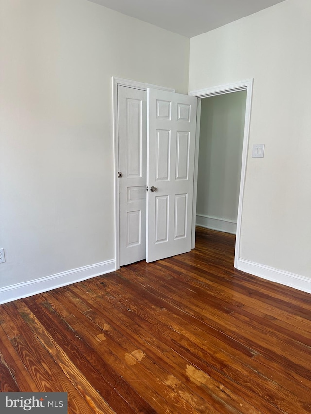 5235 Baltimore Ave, Philadelphia, PA 19143 - unfurnished bedroom with dark wood-style floors and baseboards