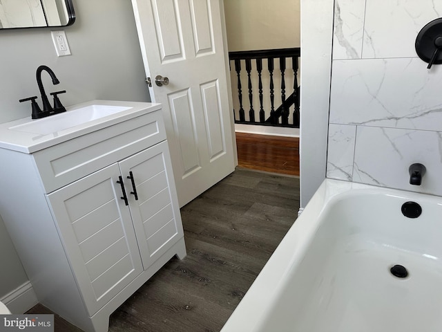 5235 Baltimore Ave, Philadelphia, PA 19143 - bathroom with wood finished floors, vanity, and a tub to relax in