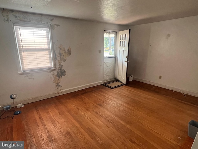 1969 Victory Dr, Baltimore, MD 21227 - spare room with baseboards, light wood-style floors, and a textured ceiling