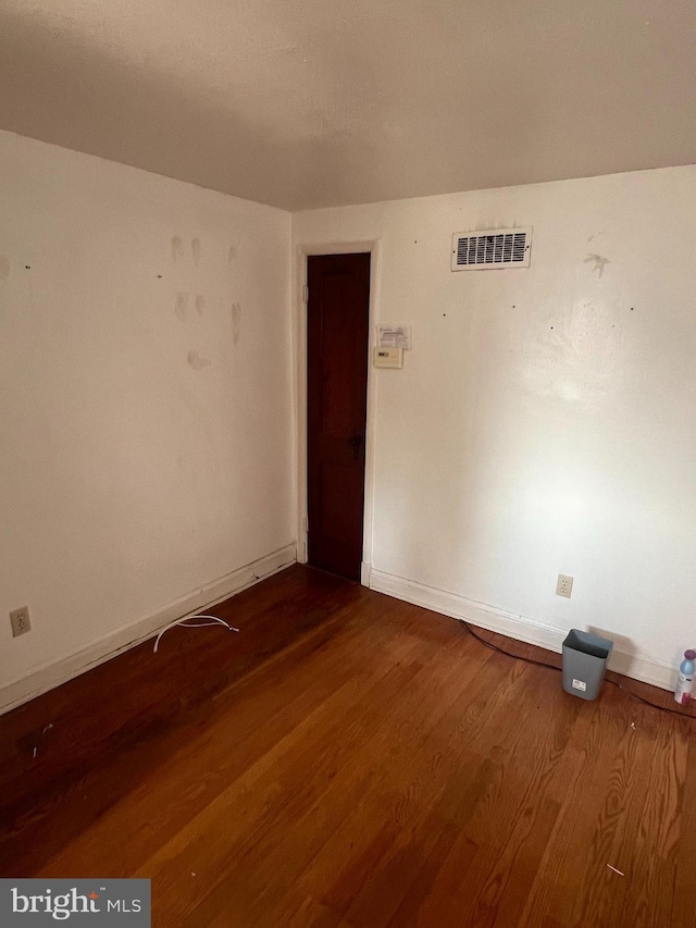 1969 Victory Dr, Baltimore, MD 21227 - empty room featuring baseboards and dark wood-type flooring