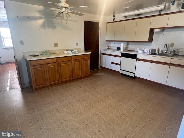 1969 Victory Dr, Baltimore, MD 21227 - kitchen with white dishwasher, light countertops, a sink, a ceiling fan, and light floors