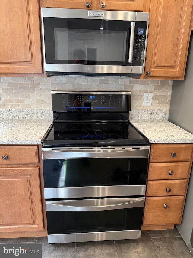 5147 Dudley Ln Unit 44, Bethesda, MD 20814 - kitchen with appliances with stainless steel finishes, tasteful backsplash, and light stone countertops