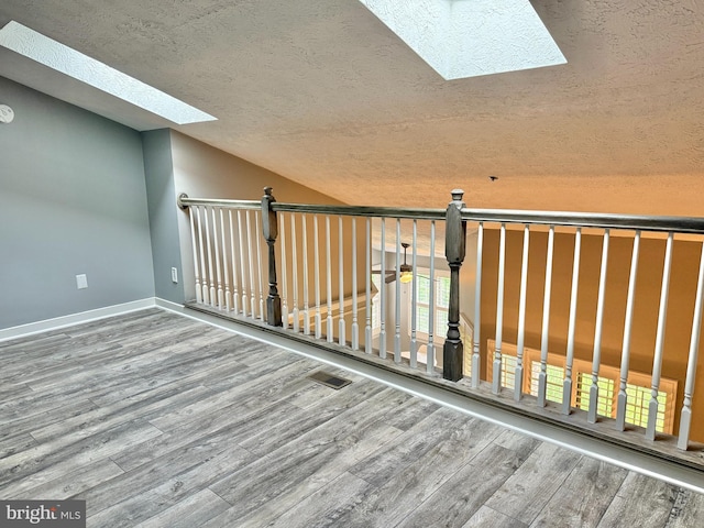 104 Gwen Dr Unit 104-3B, Forest Hill, MD 21050 - additional living space featuring a skylight, a textured ceiling, wood finished floors, and lofted ceiling