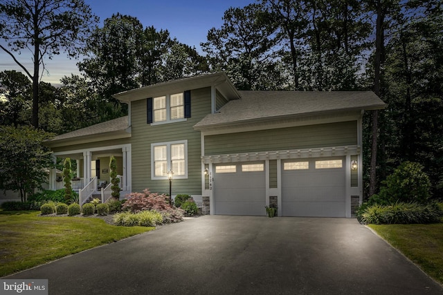 11742 Maid At Arms Ln, Berlin, MD 21811 - view of front of house featuring driveway, an attached garage, a front yard, a porch, and stone siding