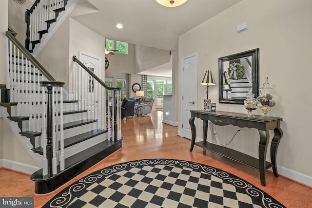 11742 Maid At Arms Ln, Berlin, MD 21811 - entryway with stairs, wood finished floors, baseboards, a towering ceiling, and recessed lighting