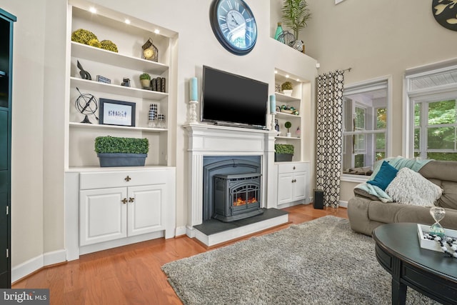 11742 Maid At Arms Ln, Berlin, MD 21811 - living area featuring light wood finished floors, built in features, and baseboards