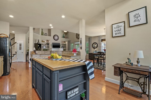 11742 Maid At Arms Ln, Berlin, MD 21811 - kitchen featuring freestanding refrigerator, butcher block counters, baseboards, open floor plan, and open shelves