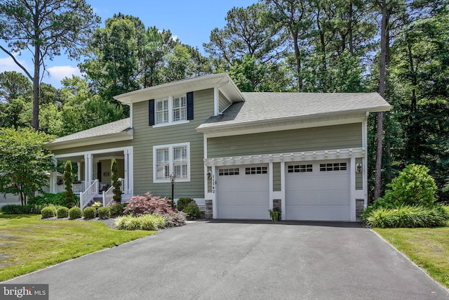 11742 Maid At Arms Ln, Berlin, MD 21811 - view of front of house featuring a garage, asphalt driveway, a front yard, and roof with shingles