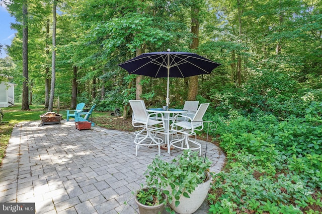 11742 Maid At Arms Ln, Berlin, MD 21811 - view of patio featuring a fire pit and outdoor dining space