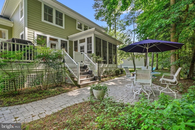 11742 Maid At Arms Ln, Berlin, MD 21811 - back of house with a sunroom, a patio, and outdoor dining space