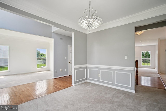 1624 Osprey Cir, Cambridge, MD 21613 - carpeted empty room with a chandelier, ornamental molding, and hardwood / wood-style floors