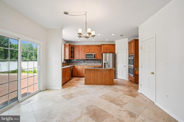 1624 Osprey Cir, Cambridge, MD 21613 - kitchen with appliances with stainless steel finishes, a chandelier, decorative backsplash, brown cabinets, and glass insert cabinets