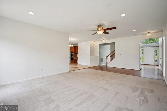1624 Osprey Cir, Cambridge, MD 21613 - unfurnished room featuring stairway, recessed lighting, light carpet, ceiling fan, and a chandelier