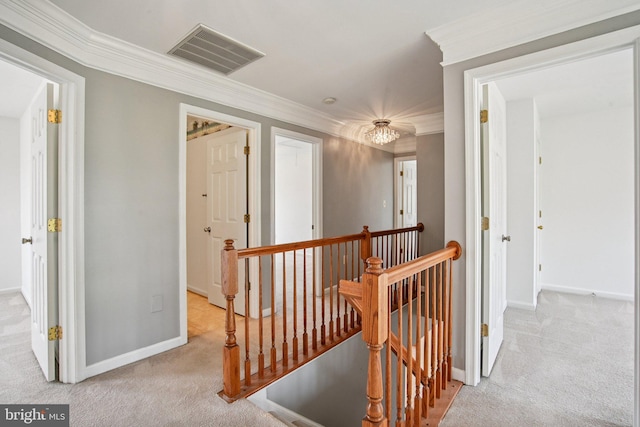 1624 Osprey Cir, Cambridge, MD 21613 - hallway featuring an upstairs landing, carpet, crown molding, and a chandelier