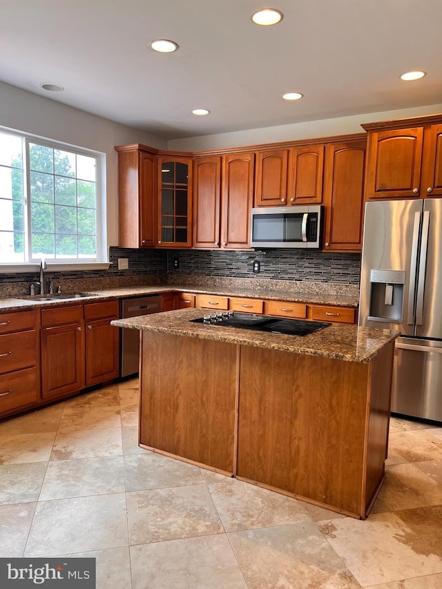 1624 Osprey Cir, Cambridge, MD 21613 - kitchen featuring appliances with stainless steel finishes, dark stone counters, backsplash, recessed lighting, and a kitchen island