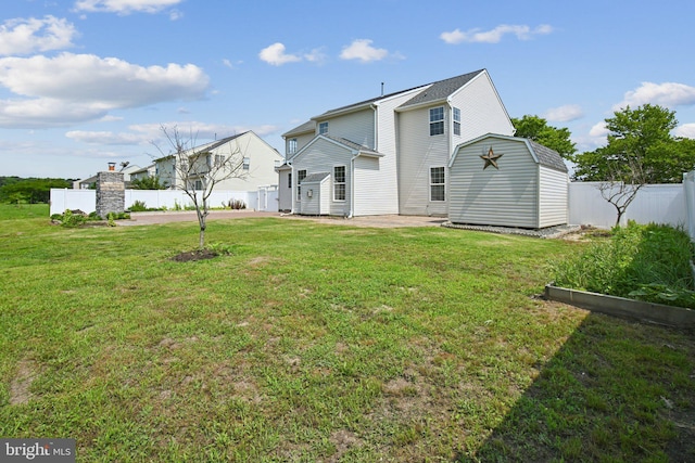 1624 Osprey Cir, Cambridge, MD 21613 - back of house featuring a storage shed, a patio, a fenced backyard, and a vegetable garden