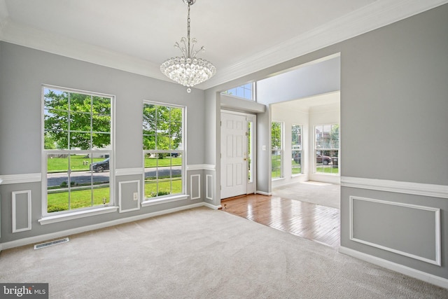 1624 Osprey Cir, Cambridge, MD 21613 - carpeted spare room with a chandelier, wainscoting, and ornamental molding