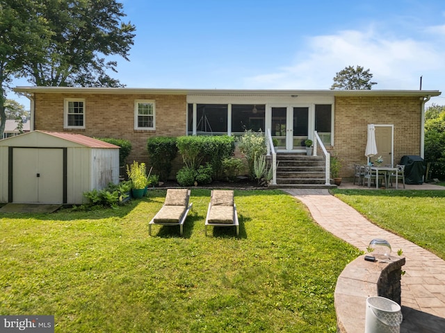 2002 Kershaw Ln, Wilmington, DE 19810 - rear view of house featuring a storage unit, brick siding, a lawn, french doors, and entry steps