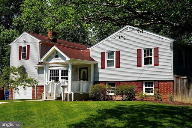 8408 Conover Pl, Alexandria, VA 22308 - tri-level home featuring a chimney, a front lawn, and brick siding