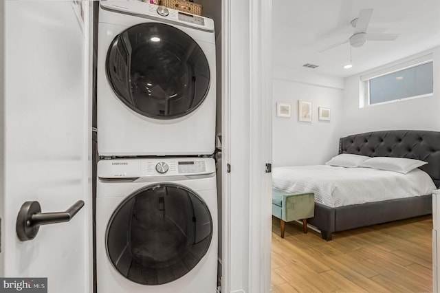 3514 13th St NW Unit 1, Washington, DC 20010 - laundry area featuring stacked washing machine and dryer, light wood-style floors, and a ceiling fan