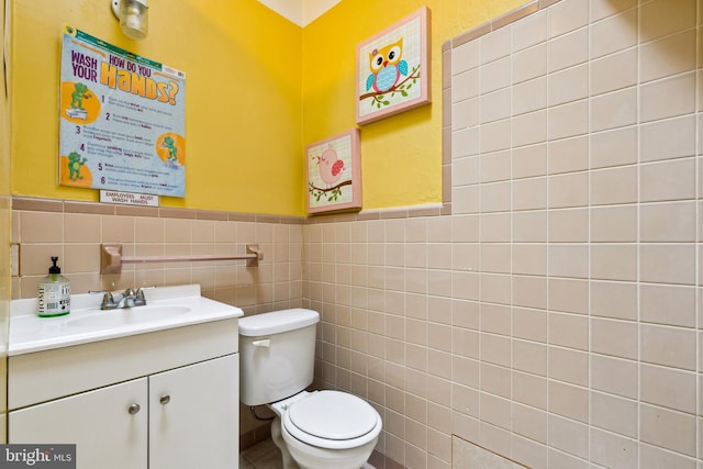 7221 W Passyunk Ave, Philadelphia, PA 19142 - bathroom featuring vanity, toilet, tile walls, and wainscoting