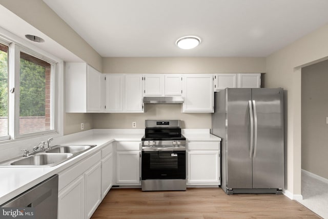1003 Cedar Park Rd, Annapolis, MD 21401 - kitchen with stainless steel appliances, range hood, white cabinetry, and light countertops