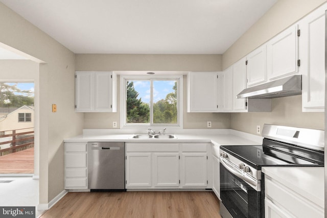 1003 Cedar Park Rd, Annapolis, MD 21401 - kitchen with appliances with stainless steel finishes, under cabinet range hood, light wood finished floors, and white cabinets