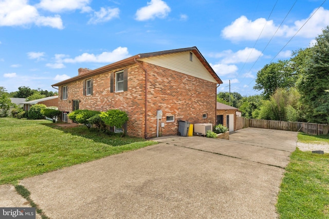1003 Cedar Park Rd, Annapolis, MD 21401 - view of side of property with concrete driveway, brick siding, a chimney, and an attached garage