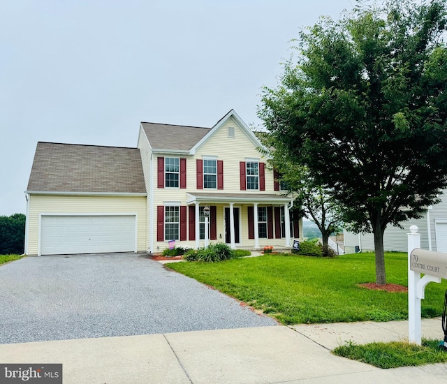 70 Centre Ct, Red Lion, PA 17356 - view of front facade featuring driveway, a porch, an attached garage, a front lawn, and a shingled roof