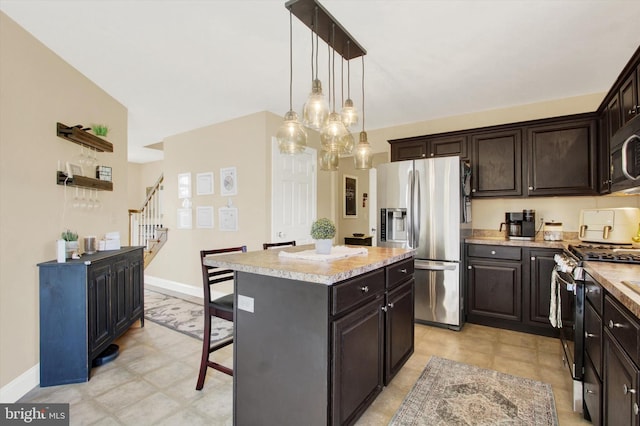 305 Old Stone Way, York, PA 17406 - kitchen featuring appliances with stainless steel finishes, a kitchen island, a kitchen bar, decorative light fixtures, and dark brown cabinetry