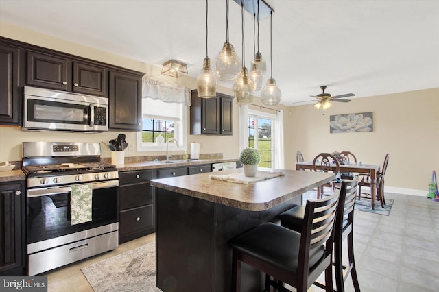 305 Old Stone Way, York, PA 17406 - kitchen featuring appliances with stainless steel finishes, a kitchen breakfast bar, a kitchen island, ceiling fan, and pendant lighting