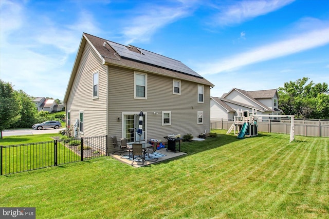 305 Old Stone Way, York, PA 17406 - back of property featuring a playground, solar panels, a fenced backyard, and a patio area