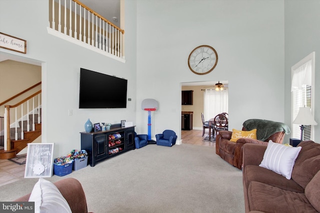 305 Old Stone Way, York, PA 17406 - living room featuring a towering ceiling, stairway, carpet, and a ceiling fan