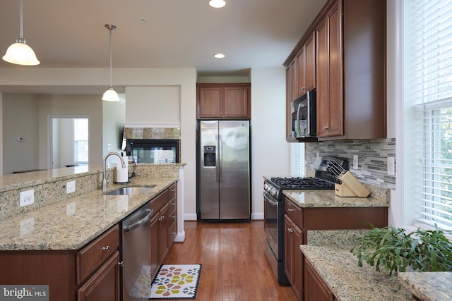 400 Blue Flax Pl, Gaithersburg, MD 20878 - kitchen with stainless steel appliances, decorative backsplash, wood-type flooring, hanging light fixtures, and light stone counters
