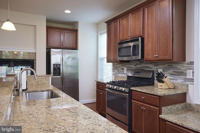400 Blue Flax Pl, Gaithersburg, MD 20878 - kitchen with stainless steel appliances, light stone counters, tasteful backsplash, hanging light fixtures, and recessed lighting