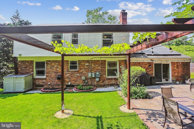 8600 Fox Run, Potomac, MD 20854 - back of house featuring a chimney, brick siding, a lawn, and a patio